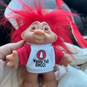 Playful Red-Haired Troll Doll with Bingo Shirt